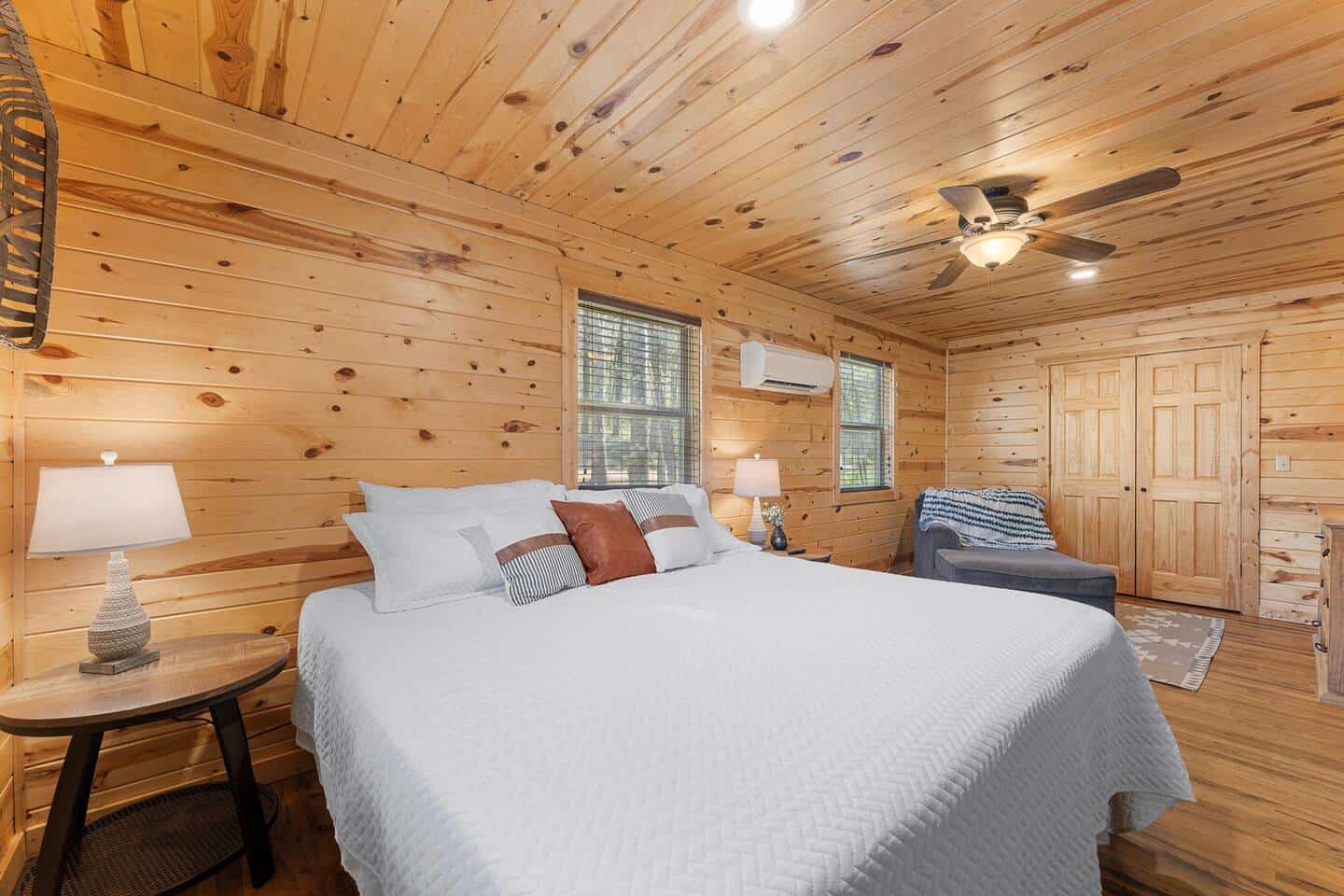 Comfortable wooden cabin bedroom with a large bed, soft lighting, and rustic decor at Soulfit Retrea.